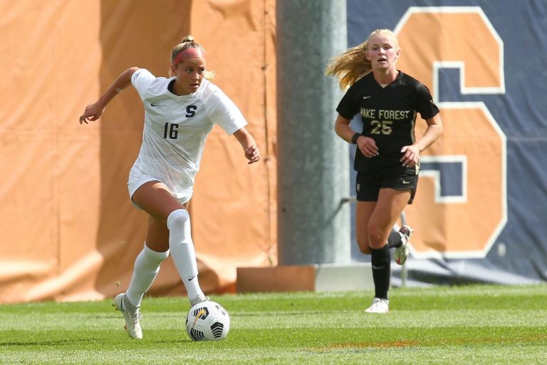 Syracuse's Koby Commandant (16) dribbles past Wake Forest's Sophie Faircloth (25) on Sunday's match at SU Soccer Stadium.